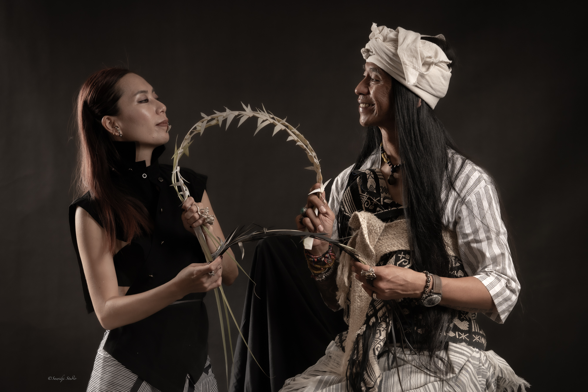 kitapoleng-founder-dibal-and-jasmine-looking-at-ech-other-holding-ornament